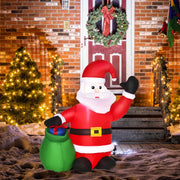 Inflatable Santa with a green gift sack beside a front door with a wreath, a lit tree and snow