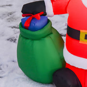 Close-up of the green gift sack with a blue gift on top beside the Santa
