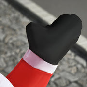 Close-up of the Santa black mitten and red sleeve against a stone surface