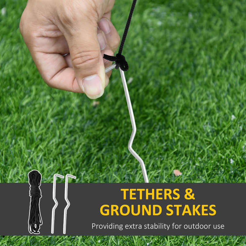 Ground stake and tether rope being fixed into grass, with a rope coil and stakes shown