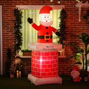 Inflatable chimney Santa lit up in front of a brick house window