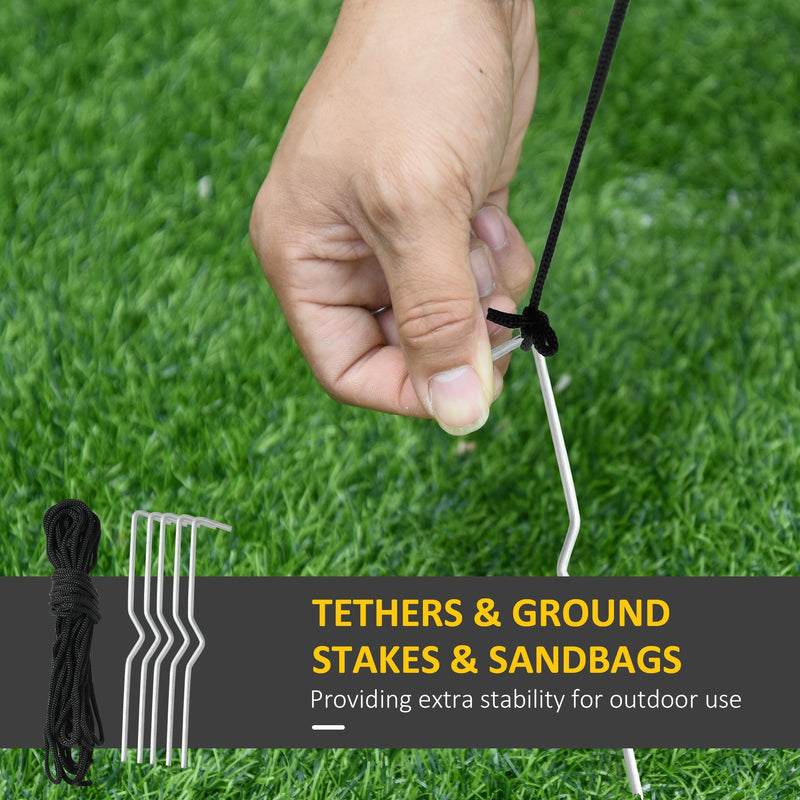 Ground stake and tether rope being fixed into grass, with five stakes and a rope coil shown