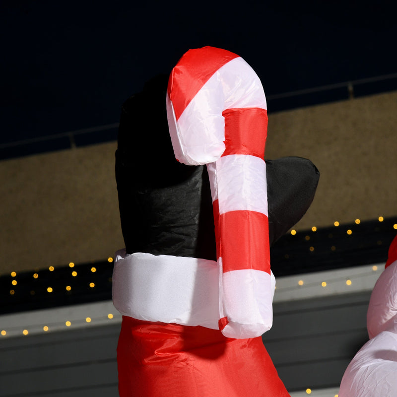 Close-up of the candy cane held in the Santa raised hand