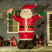 Lit inflatable Santa standing outside a house with gift sack and decorations