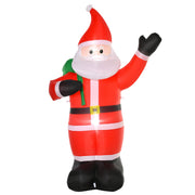 Red inflatable Santa waving with a green sack on his back, studio shot from a slight angle