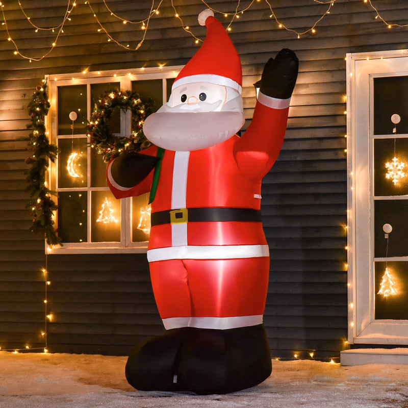 Inflatable Santa lit up at night outside a brick house with a wreathed front door