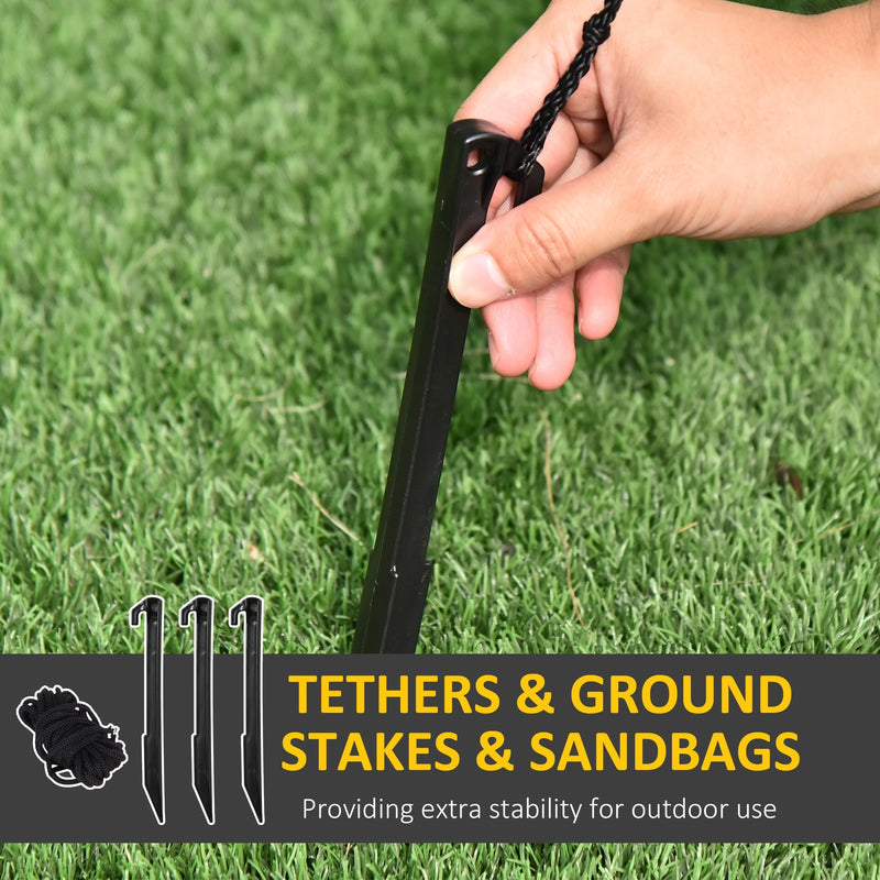 Ground stakes, tether rope coil and a hand fixing a stake into grass
