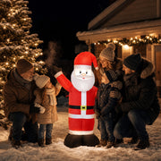 Family and children gathered around the lit inflatable Santa at a snowy Christmas market