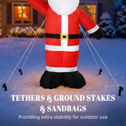 Santa held steady by tether ropes and ground stakes on a snowy lawn