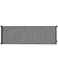 Black retractable mesh dog gate fully extended on a white background