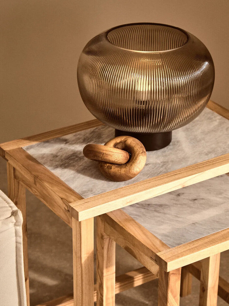 Ribbed glass globe table lamp styled in a room setting