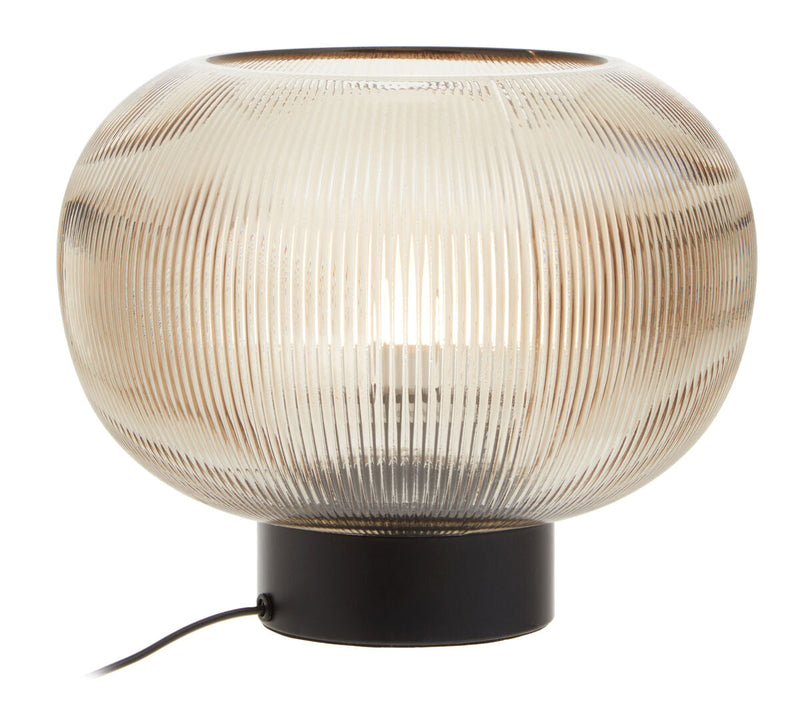 Ribbed smoked glass globe lamp with black metal base on a plain background
