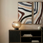 Ribbed smoked glass lamp on a bedside table