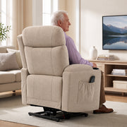 Rear view of the beige riser recliner with a side pocket, with a man seated watching TV