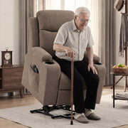 Older man seated with a cane in the brown riser recliner while it is raised on its lift base