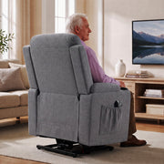 Rear view of the dark grey riser recliner with a side pocket, with a man seated watching TV