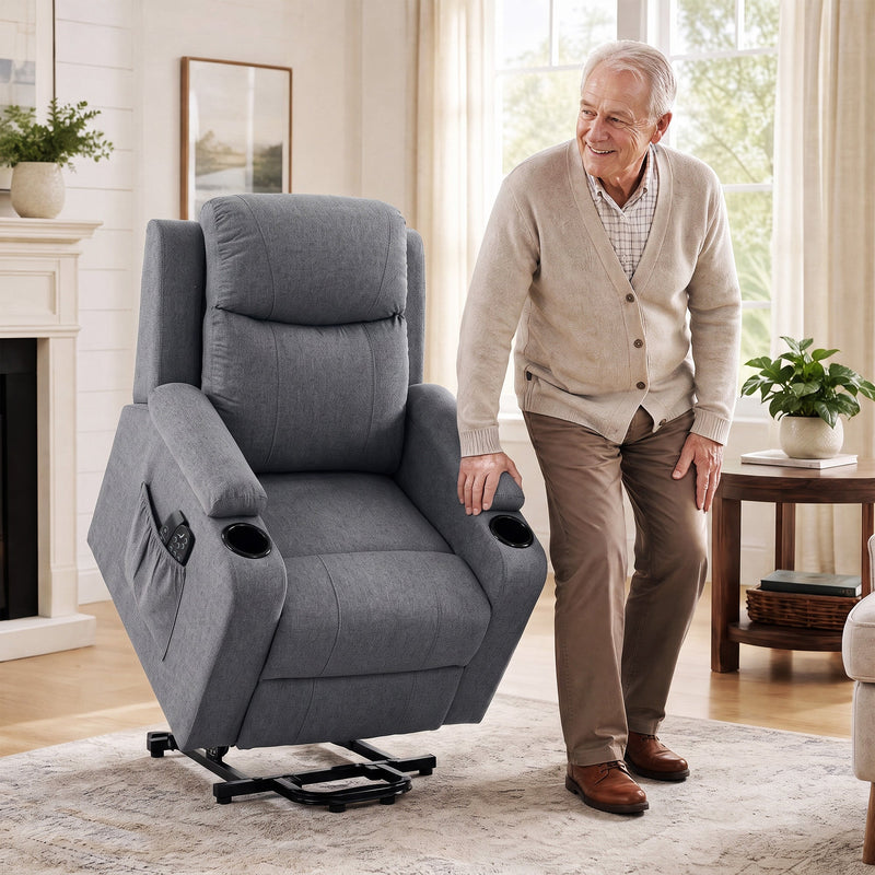 Older man standing up beside the dark grey riser recliner raised on its lift base