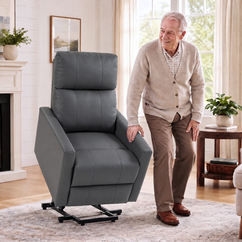 Man standing beside the dark grey riser recliner with its lift base raised