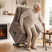 Older man leaning on a walking stick as the lift chair tilts forward to help him stand