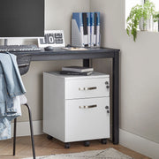 White file cabinet parked under a dark home office desk with two books stacked on top