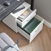 Overhead view of both drawers open, with stationery on top and green hanging files below