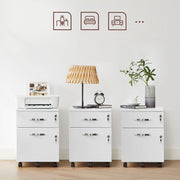 Three white file cabinets side by side styled with a printer, a table lamp and books