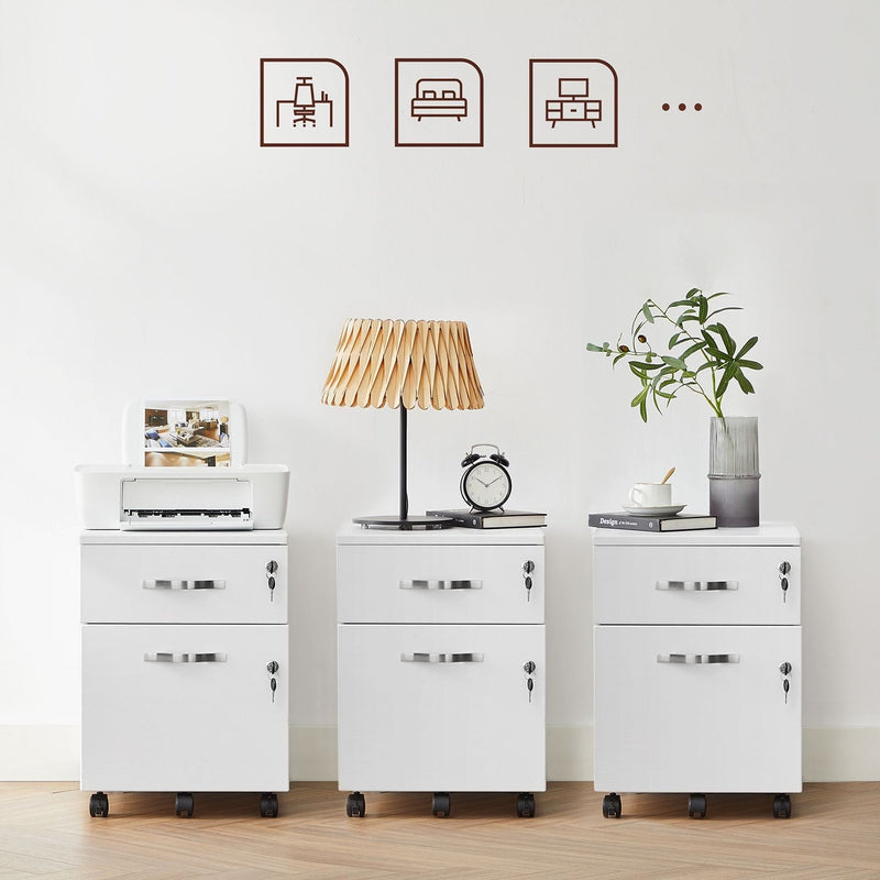 Three white file cabinets side by side styled with a printer, a table lamp and books