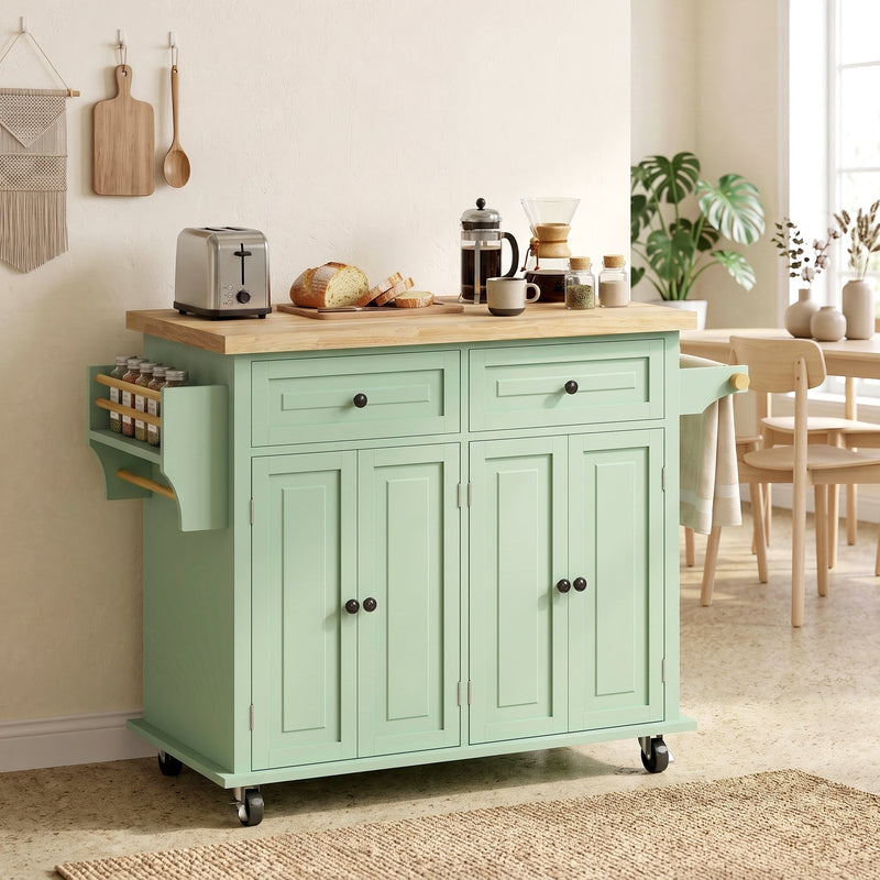 Kitchen island styled in a dining area next to a wooden table and chairs