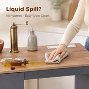 Close-up of the grey melamine worktop being wiped clean