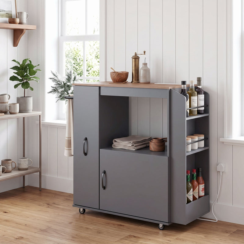 Grey kitchen trolley in a kitchen with cookware and utensils on the open shelf