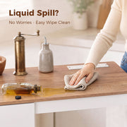 Close-up of the melamine worktop with a spilled liquid being wiped clean