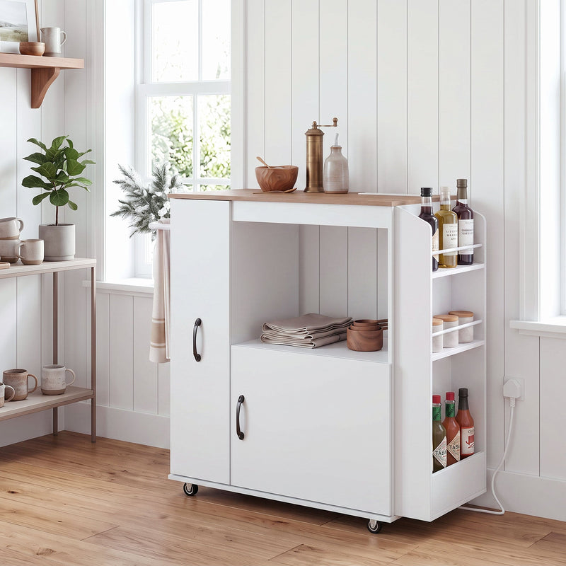 White kitchen trolley in a kitchen with cookware and utensils on the open shelf