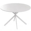 White round dining table with X-shaped white steel legs on a plain background