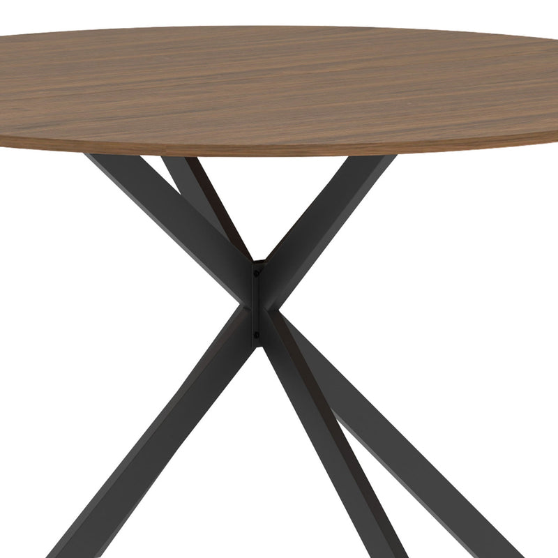 Close-up of the crossed black steel legs meeting under the wood-effect top