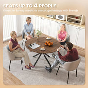 Four people seated around the round dining table in a kitchen