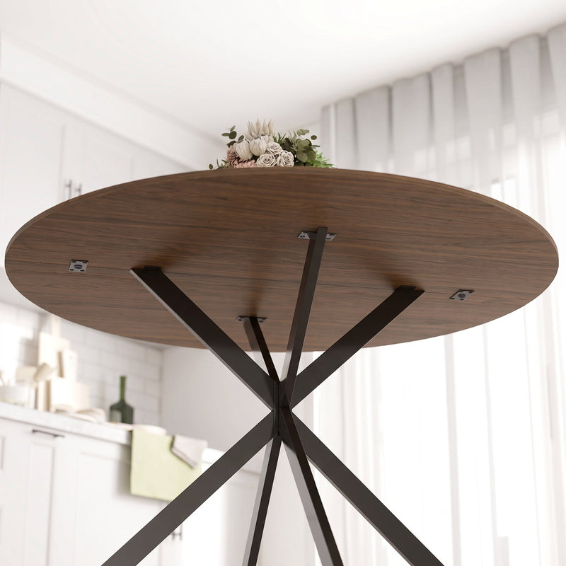 Underside of the round tabletop showing the steel leg fixings