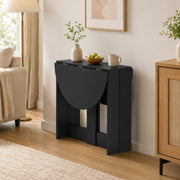 Black folding dining table set for a meal with two chairs