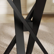 Close-up of the crossing black steel table legs on a beige rug