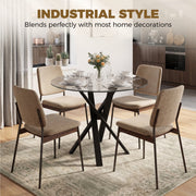 Glass dining table with beige upholstered chairs in an industrial-style kitchen