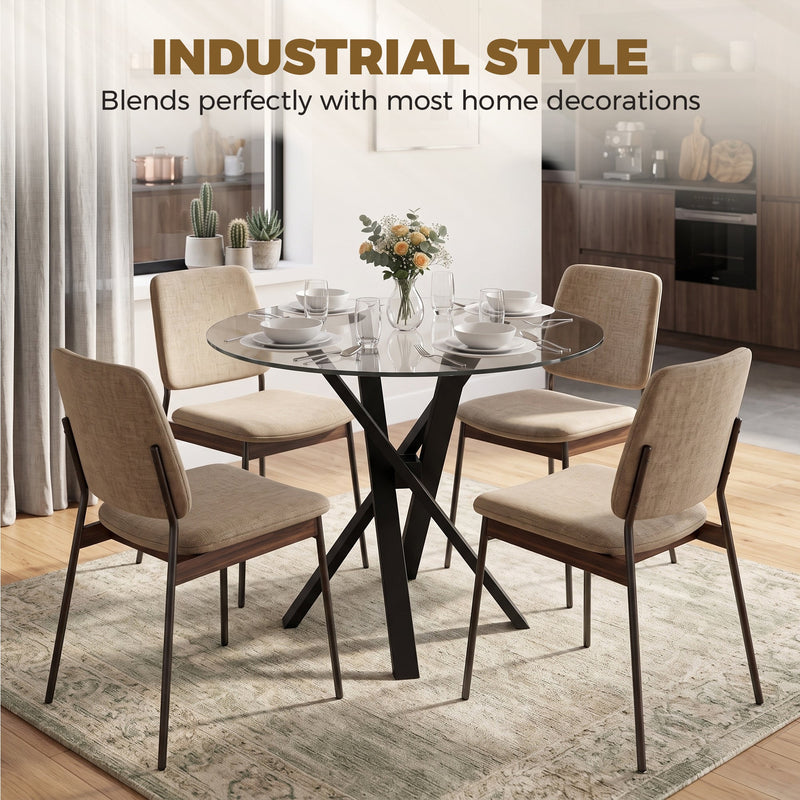 Glass dining table with beige upholstered chairs in an industrial-style kitchen