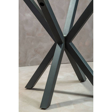 Round glass dining table with grey metal legs, studio shot