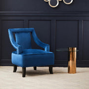 Rose gold and glass side table in a living room next to an accent chair