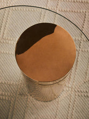 Rose gold side table shown in a neutral, blush-toned living room scheme