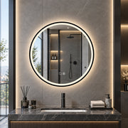 Black framed LED mirror glowing above a stone vanity with a shower behind