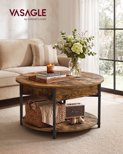 Round rustic brown coffee table in a living room in front of a sofa with a vase and candle on top