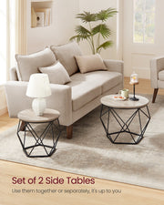 Lifestyle photo of the two nesting coffee tables on a rug in a living room labelled Set of 2 Side Tables