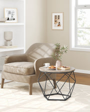 Lifestyle photo of the large coffee table beside an armchair with coffee, macarons and a vase on top
