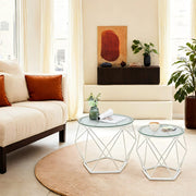 Small table nested beside the large coffee table in a living room setting