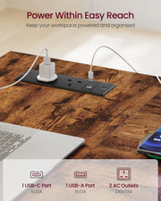 Desktop power strip with 2 UK sockets, 1 USB-C and 1 USB-A port charging a phone