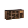 Rustic brown shoe storage bench with dark cushioned seat, 9 compartments and a drawer, studio shot